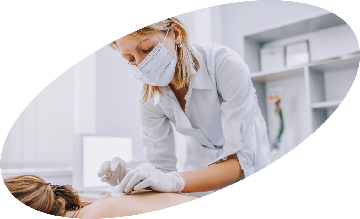 Acupuncturist treating a patient